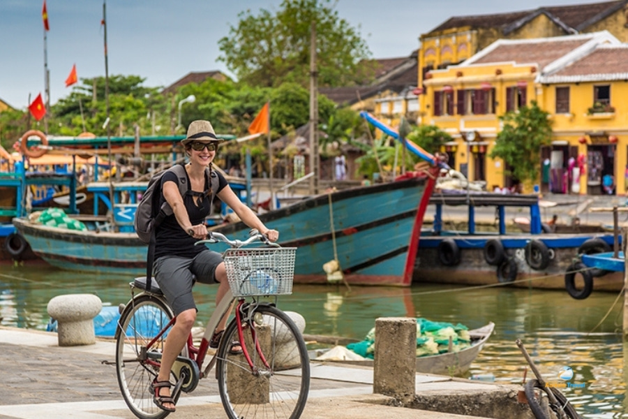 Tourist cycling along Hoi An Ancient Town riverside Vietnam – Auasia Travel
